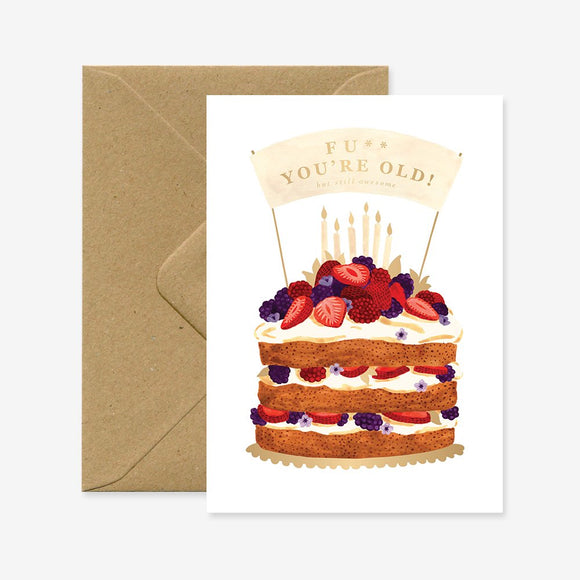 A birthday greeting card with a cake illustration and the phrase 'F*ck you're old!' on it, accompanied by a brown envelope.