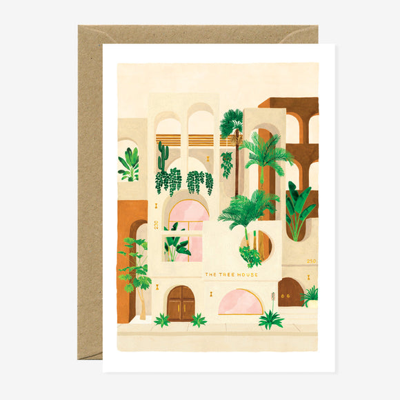 A greeting card featuring a illustration of a building with plants and geometric shapes, accompanied by a brown envelope.