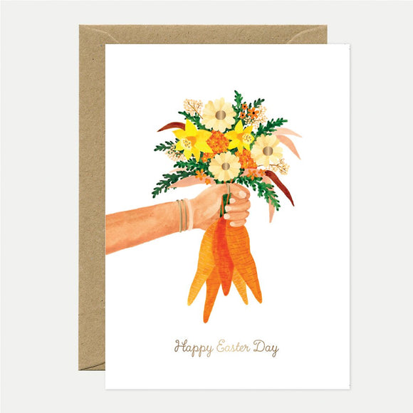 A greeting card featuring a floral design with gold foil details and the text 'Happy Easter Day' on the front, accompanied by a brown envelope.