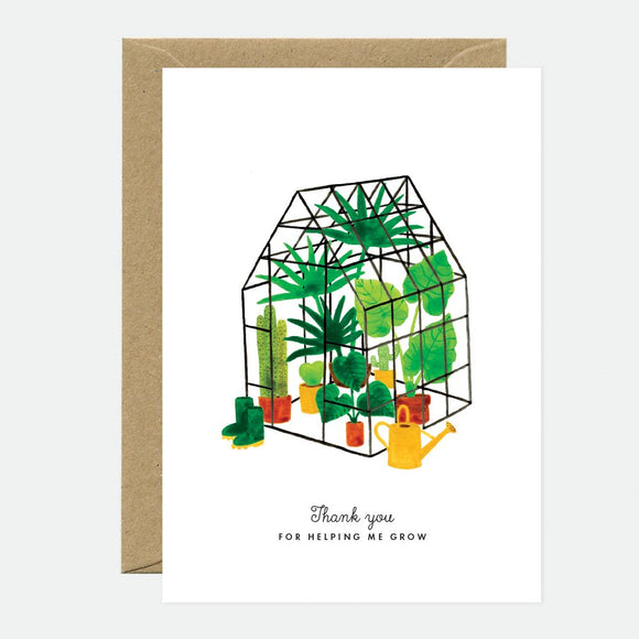 A greeting card depicting a mini greenhouse with plants and the text 'Thank you for helping me grow', accompanied by a brown envelope.