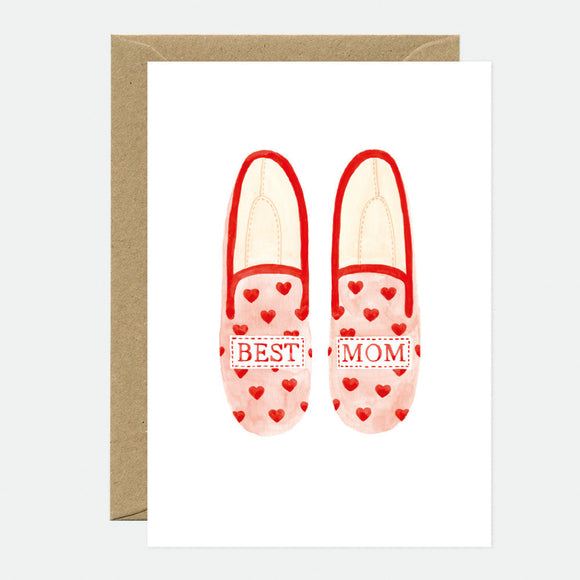 A greeting card with an illustration of a pair of red slippers with 'Best Mom' text and hearts, accompanied by a brown envelope.