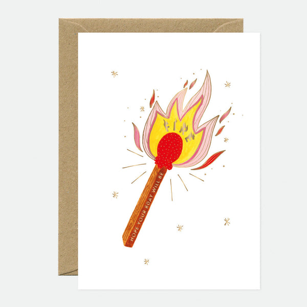 A greeting card with an illustration of a lit match and flames, accompanied by a recycled brown envelope.