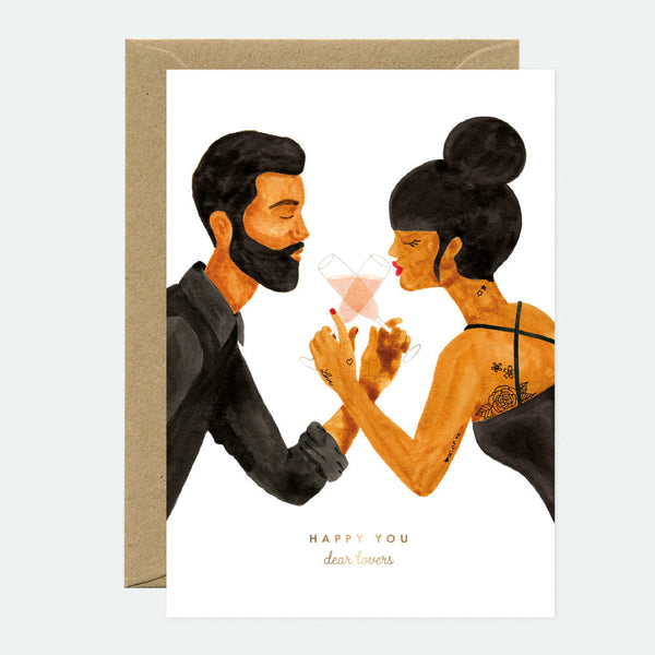 Illustrated greeting card depicting a couple kissing with a sparkler, with a gold foil finish and a text that reads 'Happy [blank]'.