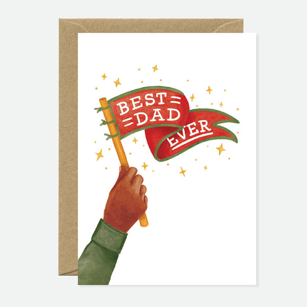 Greeting card with 'Best Dad Ever' text and a decorative banner design, held in a hand, with a brown envelope.