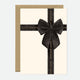 A greeting card with a black bow and 'Happy Birthday' text on it, accompanied by a brown envelope.