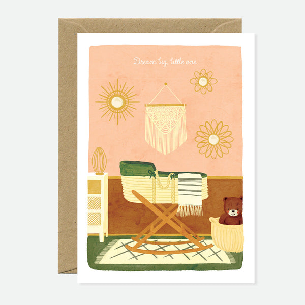 Greeting card with an illustration of a room with a chair, a bear, and a rattan chair, on a pink background, paired with a recycled brown envelope.