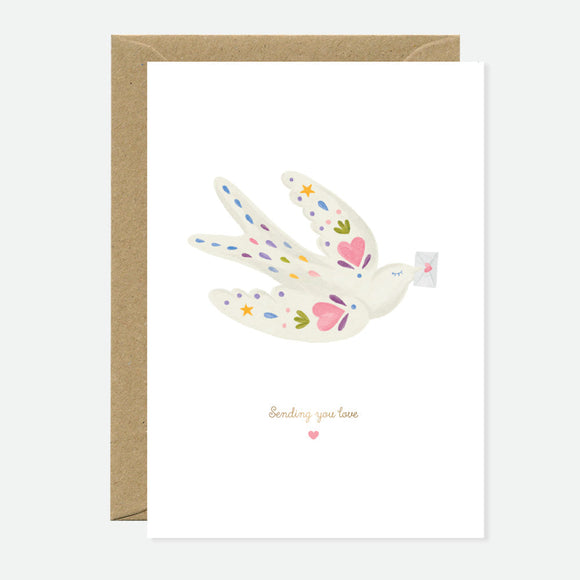 A greeting card featuring a bird design with gold foil accents, accompanied by a brown envelope.