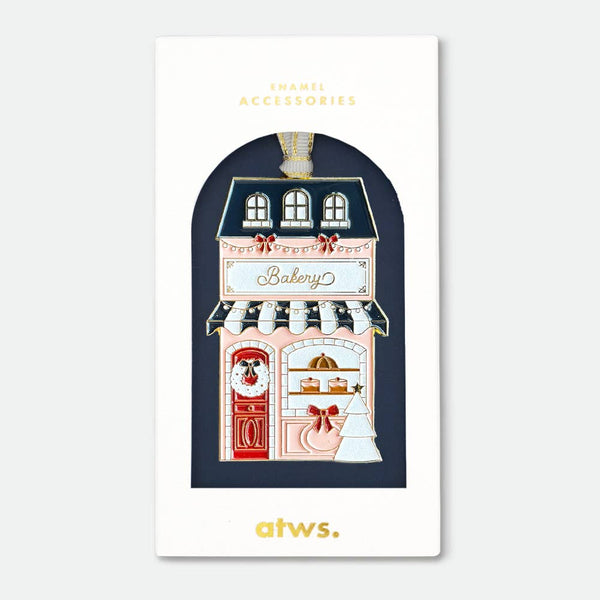 Bakery Christmas Ornament by All the Ways to Say enamel with gold plating shaped like a festive bakery storefront holiday decoration.