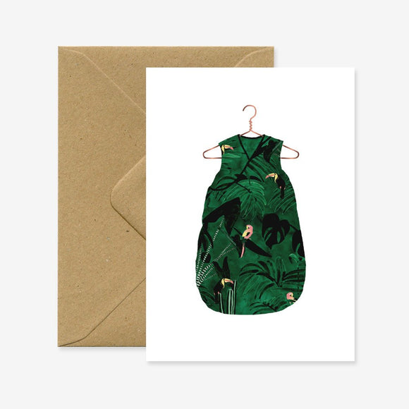 A greeting card with a green jungle pattern and a brown envelope