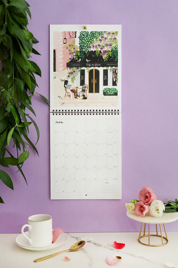June page of Travel Bucket List 2026 calendar – Café des Fleurs illustration with pastel purple background