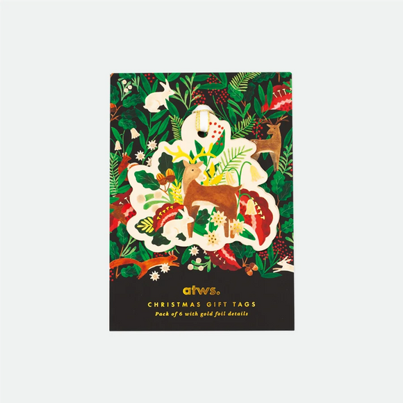 A paper gift tag with a colorful illustration of a white bunny surrounded by green leaves and red berries, with 'ATS Christmas Gift Tags' text at the bottom.