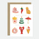 A greeting card with a variety of illustrated holiday ornaments, such as a Christmas tree, a mushroom, an ice cream cone, and an envelope, with gold foil details.