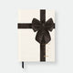 Hardcover notebook A5 with cream cover, black velvet bow illustration, gold foil details and black ribbon bookmark by All the Ways to Say.