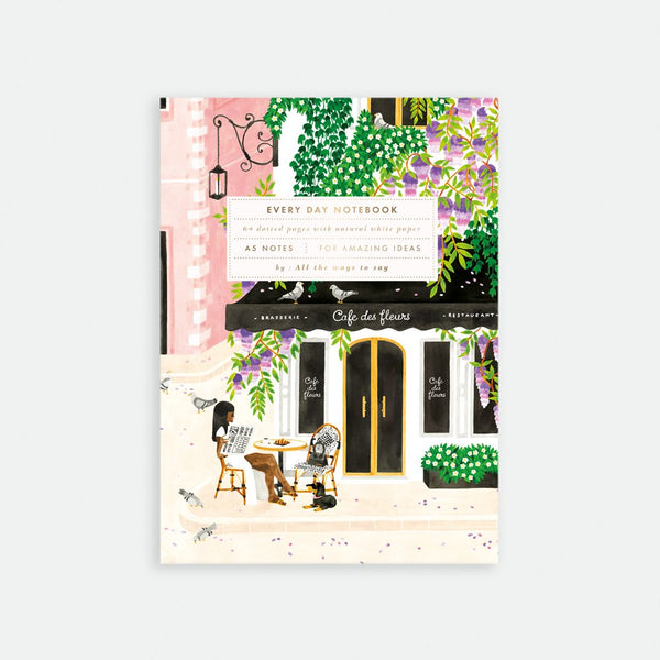 A floral-patterned notebook with an illustration of a cafe on the cover, titled 'Every Day Notebook'.
