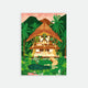 A5 notebook with a colorful cover featuring a stylized house in a tropical setting with palm trees and a thatched roof.