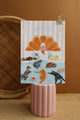 Home Sweet Home notebook by All The Ways To Say – cozy illustration of woman reading in bed surrounded by cats and dogs