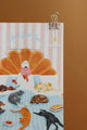 All The Ways To Say Home Sweet Home notebook close-up – woman with coffee and pets relaxing on striped blue bedspread