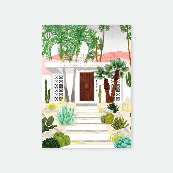 Decorative notebook cover with palm trees, cacti, and a building design.