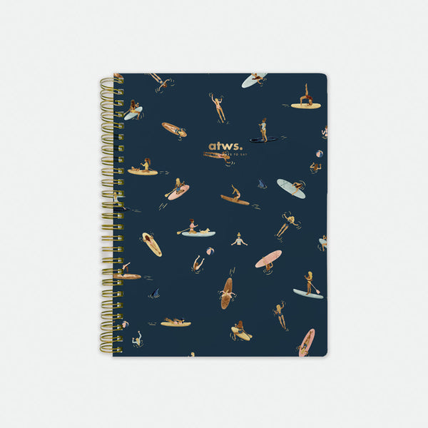 Paddle Girls Spiral Notebook – navy blue cover with playful paddleboarding and surfing illustrations, gold foil details, by All the Ways to Say.