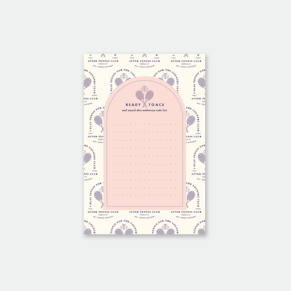 A notepad with a tennis-inspired design, featuring sports equipment and motifs in a pink color scheme.