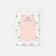 A notepad with a tennis-inspired design, featuring sports equipment and motifs in a pink color scheme.