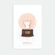 Angel enamel pin by All the Ways to Say featuring gold-plated angel design inside illustrated Christmas snow globe background with soft pink tones.