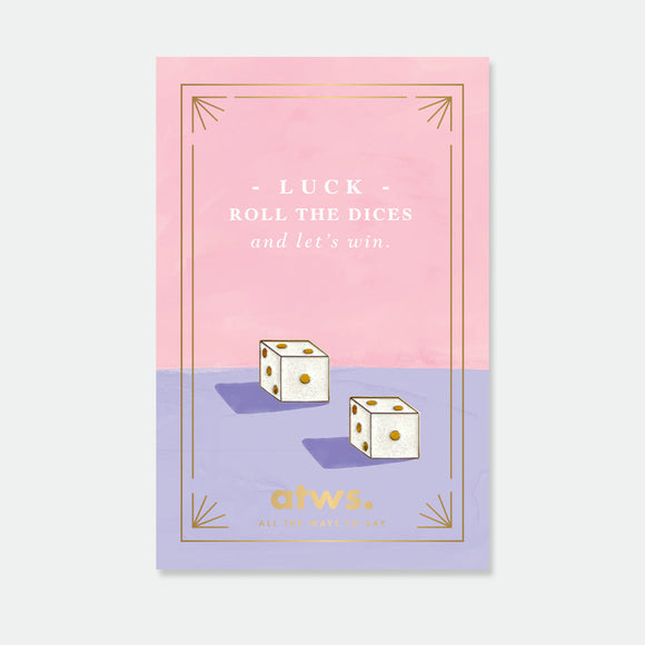 Casino enamel pin by All the Ways to Say featuring gold-plated dice design on pink and lilac background with elegant golden frame.