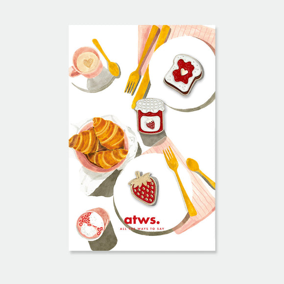 Jam Lover enamel pin set by All the Ways to Say featuring toast with heart, jam jar and strawberry, gold-plated details on illustrated breakfast background.