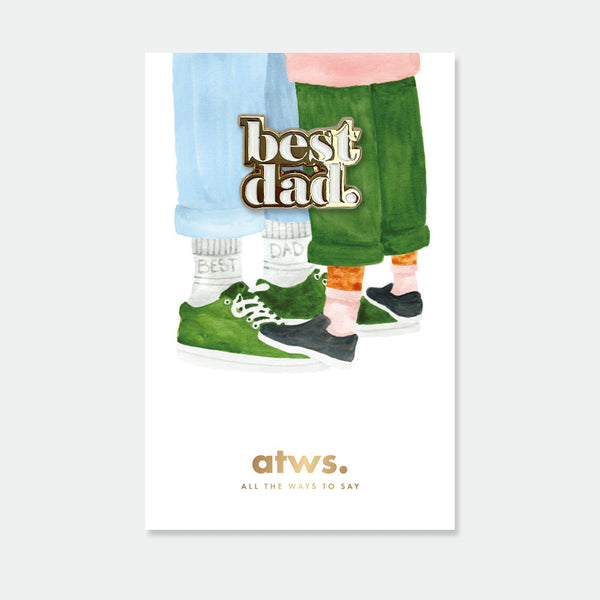 Best Dad enamel pin by All the Ways to Say featuring gold-plated “Best Dad” text, elegant design on illustrated background with father and child sneakers.