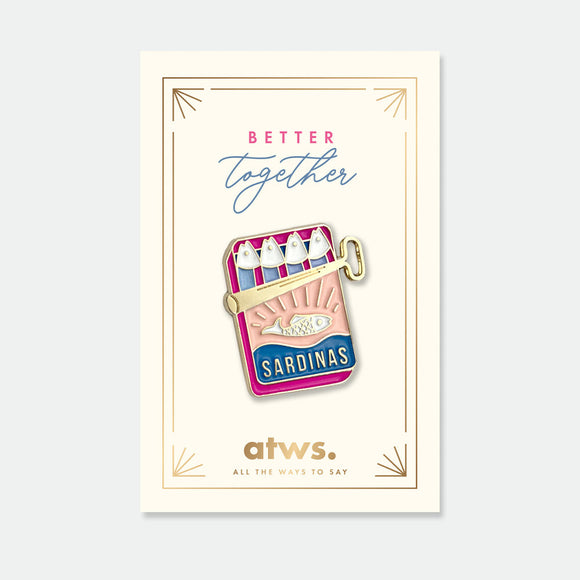 Better Together enamel pin by All the Ways to Say featuring gold-plated sardine tin design in pink and blue tones on cream background with golden frame.