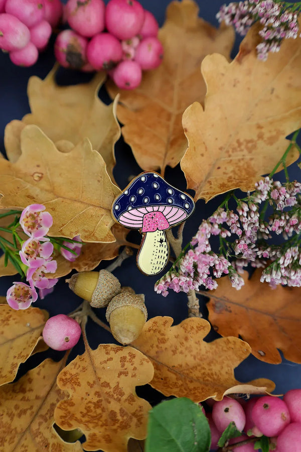 Crazy Mushroom enamel pin by All The Ways To Say – navy blue and pink mushroom among oak leaves and pink berries