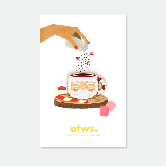 Santa Cup enamel pin by All the Ways to Say featuring Santa mug design with gold-plated details on festive background with marshmallows and candy canes.