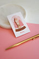 Pink Nutcracker enamel pin by All The Ways To Say on gift card – Christmas nutcracker design with pink trees and gold details