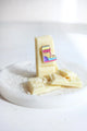 Cold AF enamel pin by All The Ways To Say – fun winter boot design on white chocolate with snow-like sprinkles