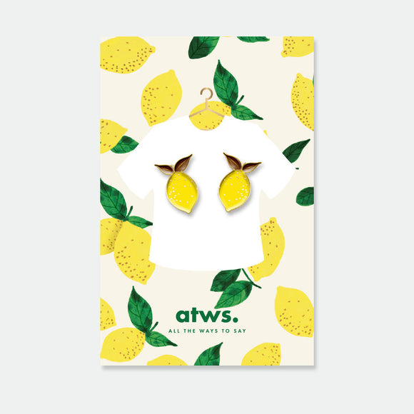 Lemons enamel pins set by All the Ways to Say featuring two gold-plated lemon designs on illustrated citrus background.