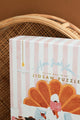 Close-up of Home Sweet Home puzzle box with pink stripes and gold lettering – cozy detail shot