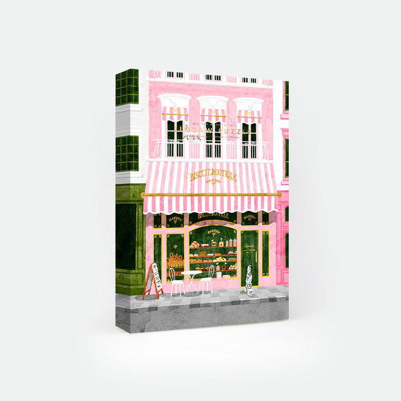 Pink Bakery jigsaw puzzle by All the Ways to Say – 1000-piece pastel Paris puzzle showing a charming pink bakery façade with cakes, cookies, and pastries.