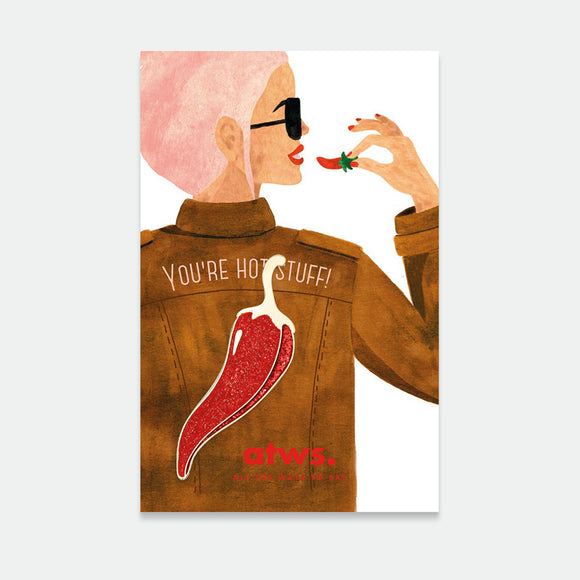 A graphic illustration of a person with pink hair wearing a brown jacket with a gold plating pin shaped like a chili pepper on it, with the text 'You're hot stuff!' and the brand name 'ATWS.'.