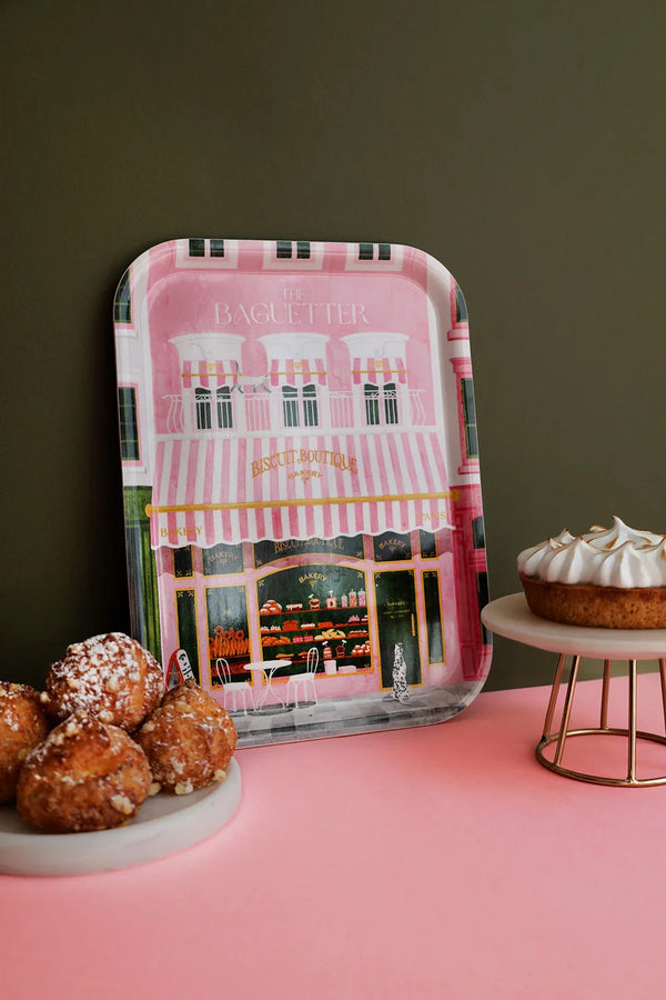 Pink Parisian bakery tray “The Baguetter” styled with pastries and a lemon meringue tart on a pink table.