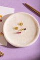 Duo Anti Idiots - Pins: overhead shot of the purple-pink and yellow-purple pill pins on a white tray.