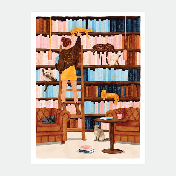 Illustrated poster of a woman on a library ladder reaching for a cat, surrounded by floor-to-ceiling bookshelves with several cats lounging among the books and armchairs, "I'M A CAT lover" text on her sweater, Booked & Busy poster by All The Ways To Say
