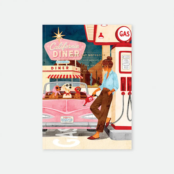 California Diner A5 notebook cover by All The Ways To Say, illustration of a woman pumping gas at a retro gas station next to a pink convertible with three dogs wearing sunglasses in the back seat, "California Diner" neon sign and desert cacti in the background, "DOGGY18" license plate