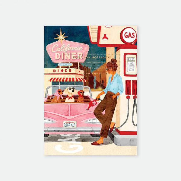 California Diner A5 notebook cover by All The Ways To Say, illustration of a woman pumping gas at a retro gas station next to a pink convertible with three dogs wearing sunglasses in the back seat, "California Diner" neon sign and desert cacti in the background, "DOGGY18" license plate