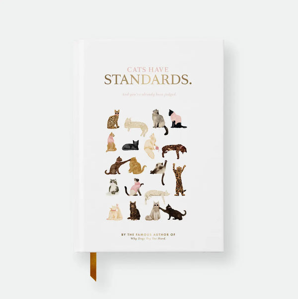 Cats Have Standards hardcover A5 notebook by All The Ways To Say, white cover styled like a book jacket with the title "Cats Have Standards, and you've already been judged," a fake author credit, and an illustrated grid of eighteen cats of different breeds and poses