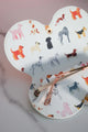 Open dog-pattern glasses case showing pink-rimmed sunglasses inside.