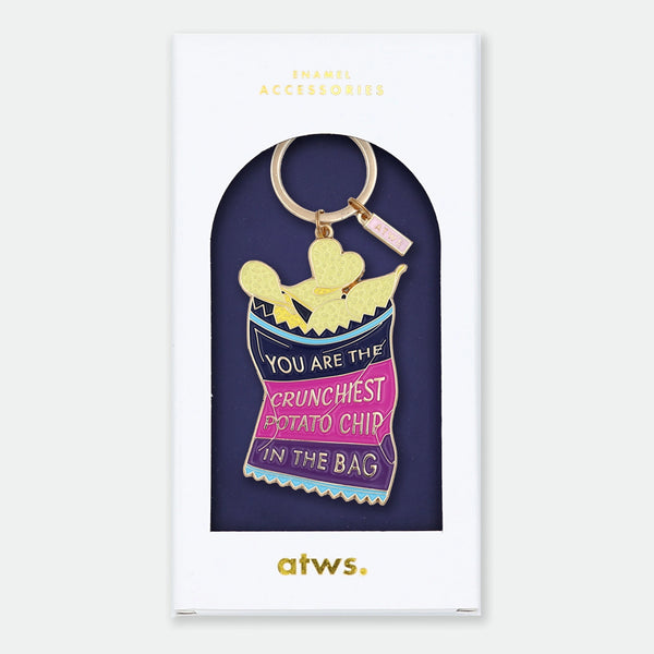 Enamel and metal keychain shaped like a bag of potato chips, navy and pink with text reading "You are the crunchiest potato chip in the bag," gold-tone ring and "ATWS" charm