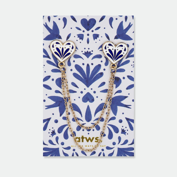 Enamel pin set of two blue and white heart-shaped pins connected by two gold chains, inspired by traditional ceramic patterns