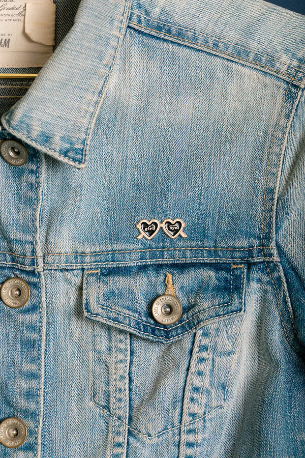 Girl Bye - Pins: stylish "girl bye" sunglasses pin worn on the pocket of a light blue denim jacket.
