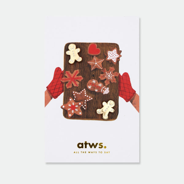 Set of two enamel pins shaped like gingerbread men, decorated with white icing details and a gold heart