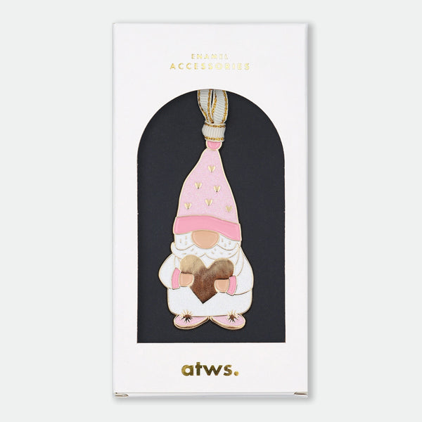 Gold-tone enamel Christmas ornament of a gnome in a pink heart-patterned hat, holding a gold heart with both hands